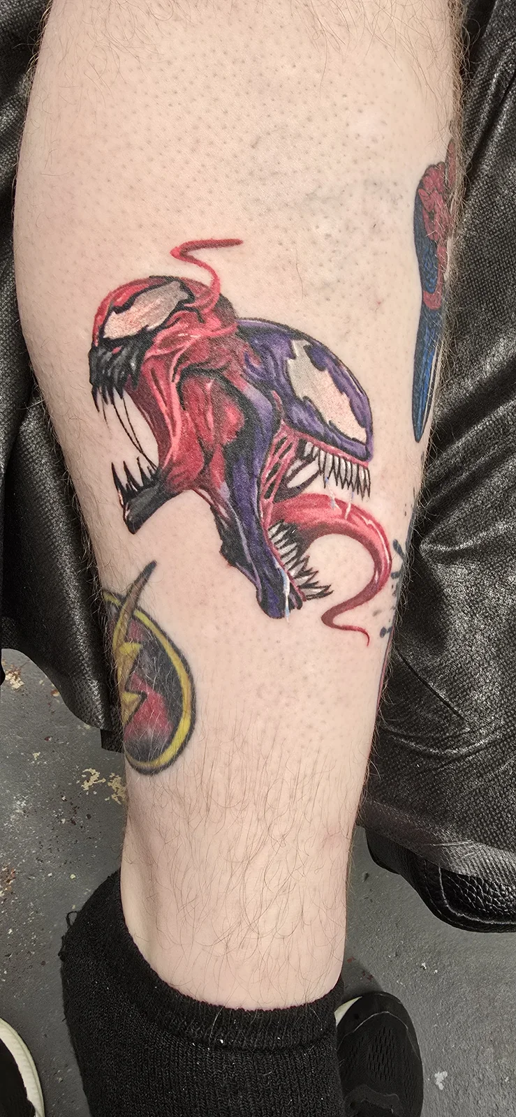Red and black creature tattoo by Branded Key Tattoo